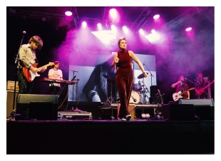 A six-piece band play onstage with their frontwoman front and centre.